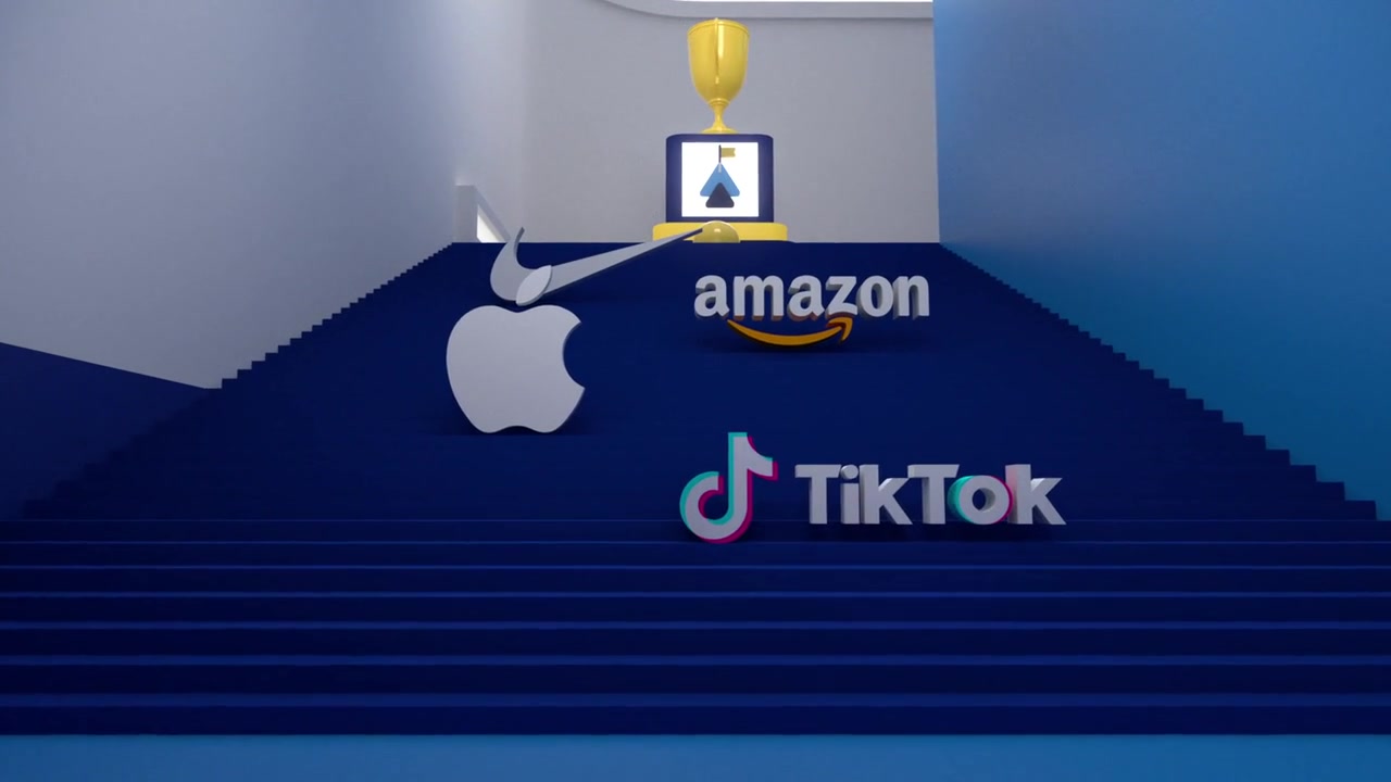 Development frame of a blue staircase with dimensional brand symbols and a trophy at the top.
